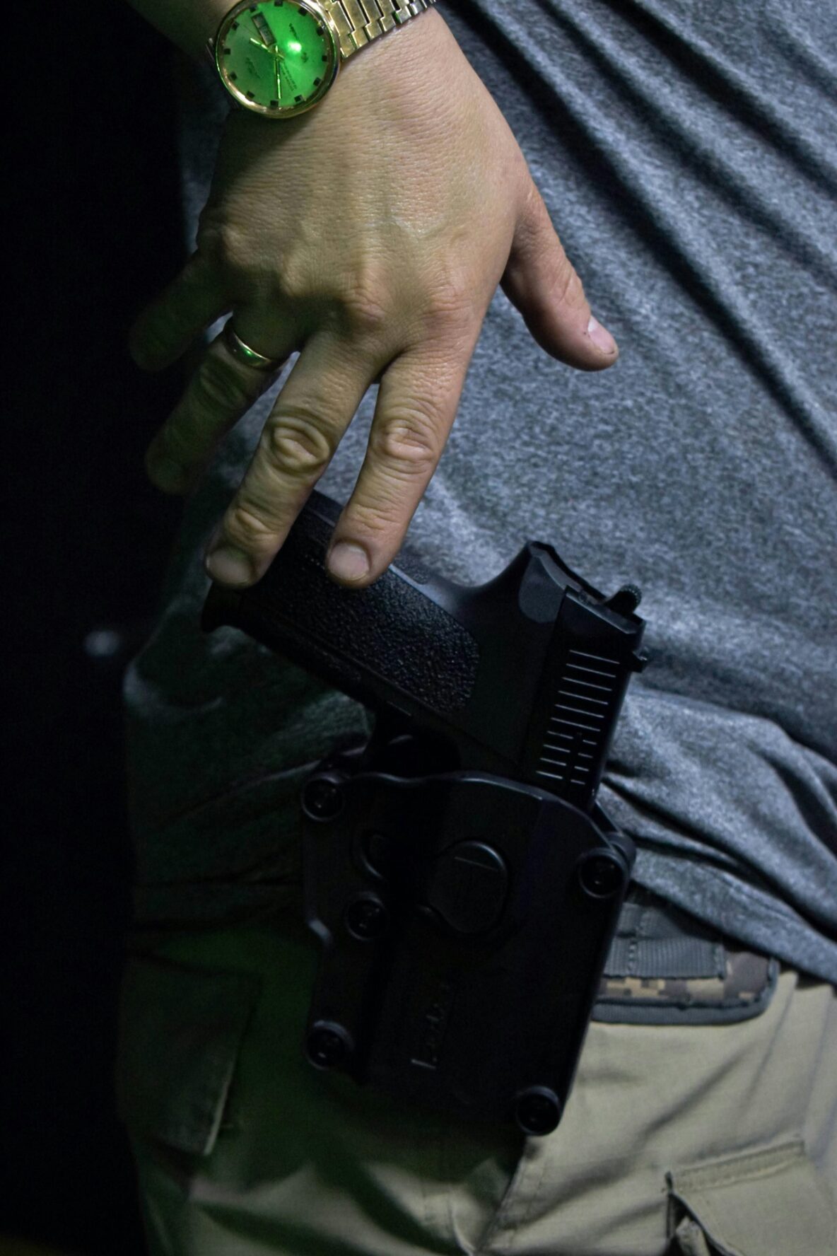 Image of a man ready to draw his weapon from his holster