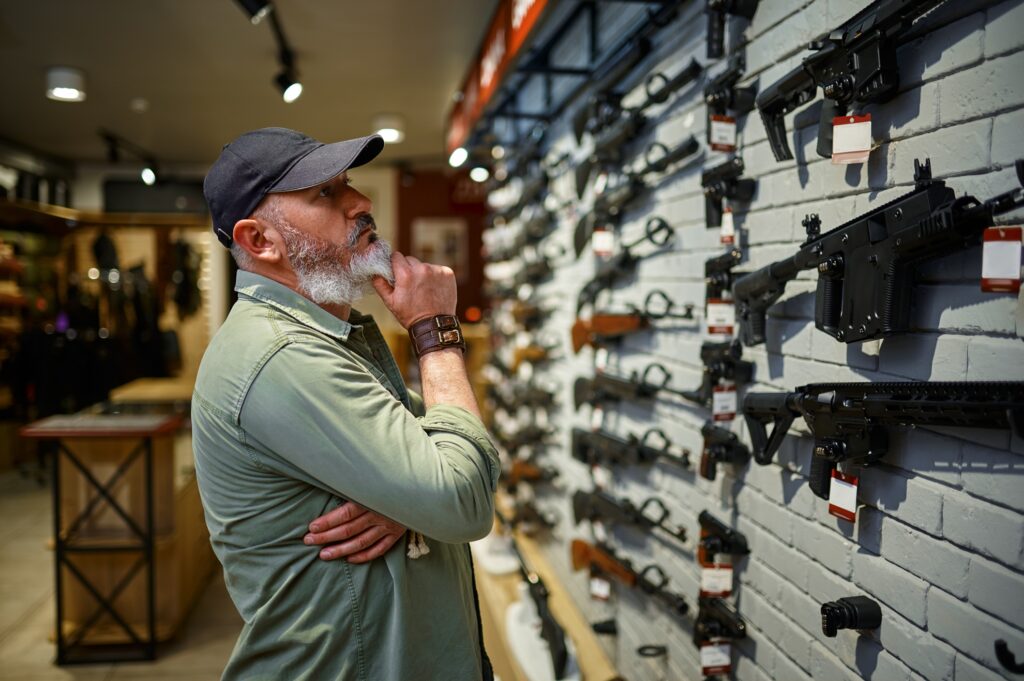 Image of a man browsing a selection of firearms at you local Albuquerque gun shop